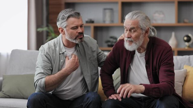 An elderly father complains about life to an adult son, which help him to calm dawn. Two generations family has conversation, sharing news, spending time together. Understanding, care and support.