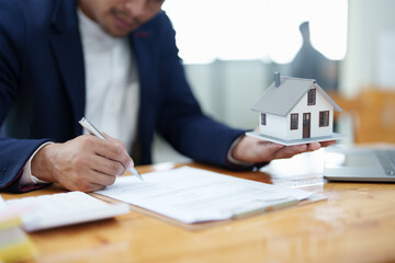 Guarantee, Mortgage, agreement, contract, Signing, Male client holding pen to reading agreement...