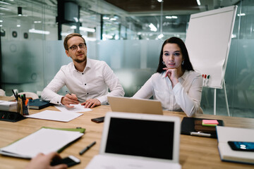 Coworkers in formal clothes working in office