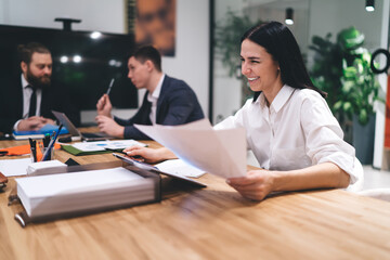Cheerful colleagues working on project in office