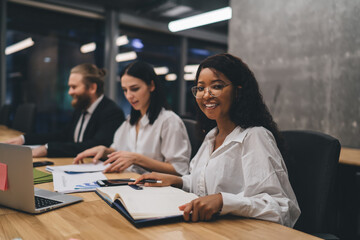 Cheerful African American businesswoman working in conference room