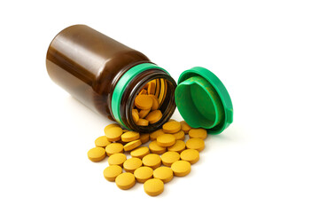 jar with turmeric pills. isolated white background