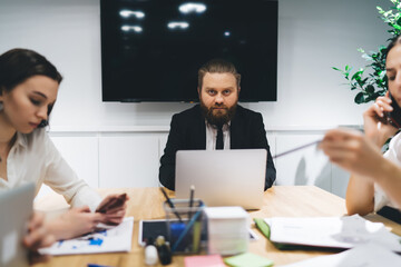 Focused colleagues working on project in boardroom