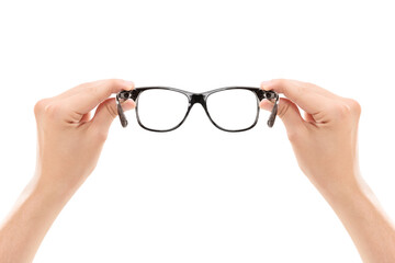 Male hands holding a pair of glasses