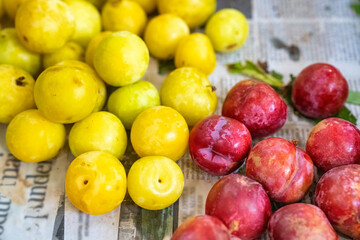 Plums fruit, yellow and red colors, on sale in a street market