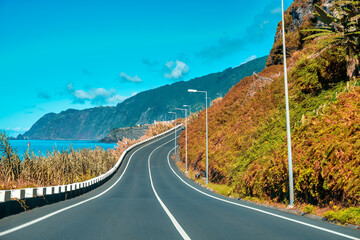 Driving along a coastline road by the ocean on a beautiful autumn day