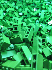 Green building pieces closeup. Bright plastic constructor pieces neatly accommodation in box container for storage