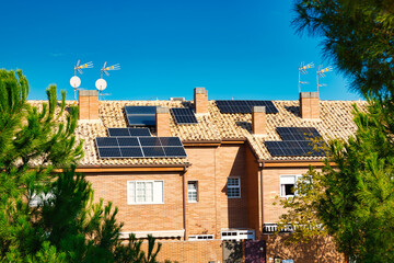 Solar energy panels on the roofs of single-family homes, in Madrid (Spain).