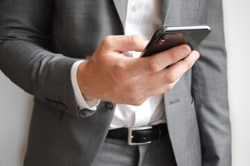 Midsection of businessman holding a mobile phone