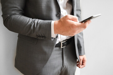 Midsection of businessman holding a mobile phone