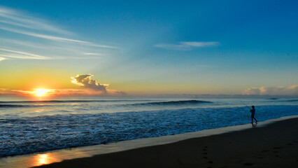 Surf-casting at dawn on a Florida beach