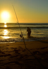 Fisherman silhouetted by sunrise in Florida