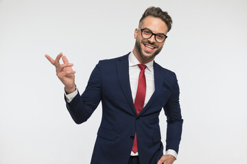 happy man with glasses laughing and pointing finger to side
