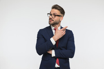 happy unshaved man with glasses looking to side and having a conversation