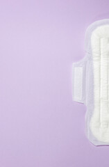 Sanitary pads lies on a purple background. Menstrual cycle and pregnancy. Negative pregnancy test and contraceptives