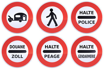 Collection of circular red, black and white road prohibition signs with the prohibition to pedestrians, vehicles towing a caravan and halt police, toll, gendarmerie in English, French and German