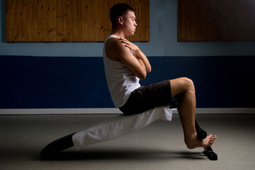 Fototapeta premium Nineteen year old teen boy doing situps in a tanktop