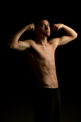 Fototapeta premium Nineteen year old teen boy flexing his arms