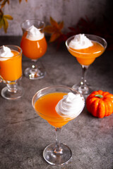 Pumpkin fall seasonal drink cocktail latte with spices and whipped cream for Thanksgiving or Halloween party festive celebrate. Autumn decoration
