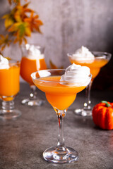 Pumpkin fall seasonal drink cocktail latte with spices and whipped cream for Thanksgiving or Halloween party festive celebrate. Autumn decoration