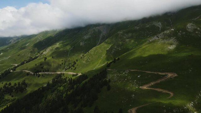 panorama of mountain peaks with clouds in summer in teberda shot on a drone