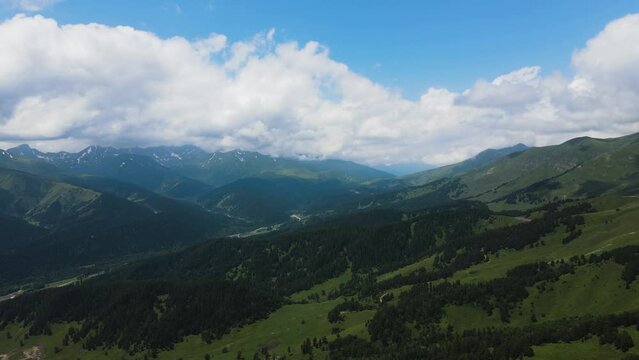 panorama of mountain peaks with clouds in summer in teberda shot on a drone