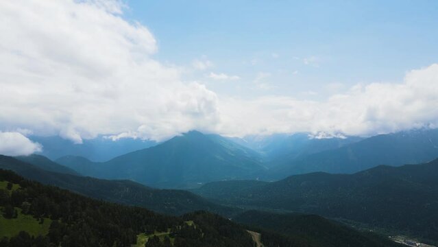 panorama of mountain peaks with clouds in summer in teberda shot on a drone