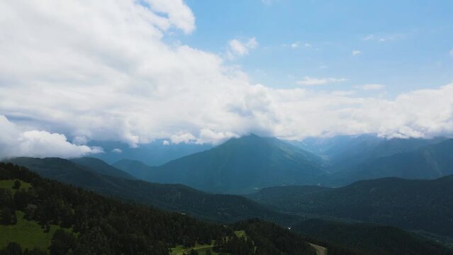panorama of mountain peaks with clouds in summer in teberda shot on a drone