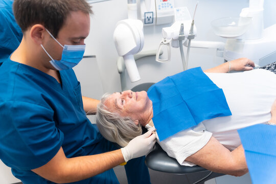 Dental clinic, elderly woman lying at the dentist on denture checkup