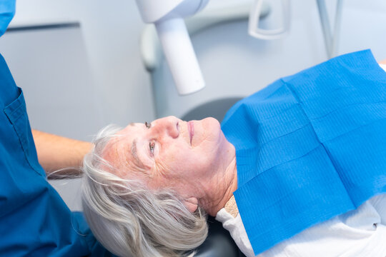 Dental clinic, elderly woman lying at the dentist on denture checkup