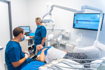 Fototapeta premium Dental clinic, dentist doctor and assistant explaining to an elderly woman the dental check-up