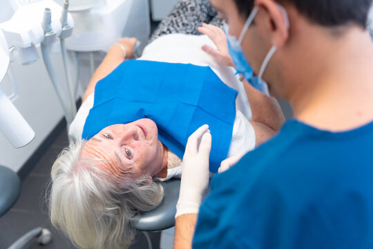 Dental clinic, doctor explaining to an elderly woman the problem she has with her teeth