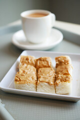 peanut butter spread on toasted bread and cup of tea on table 