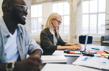 Female employee using netbook during meeting in office