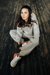 Attractive sexy woman wear warm total look. Girl look preaty. Elegant look. Brunette model wear hoody. Winter, fall autumn or spring minimal outfit. Woman is sensual.
