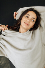 Attractive sexy woman wear warm total look. Girl look preaty. Elegant look. Brunette model wear hoody. Winter, fall autumn or spring minimal outfit. Woman is sensual.