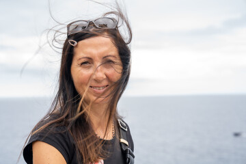 Smiling happy woman in front of the sea