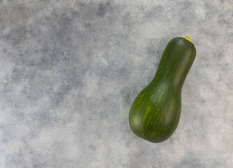 Raw zucchini on a light gray table. Top view, copy space