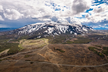 Volcanic mountain and dirt road on summer in highlands of Iceland