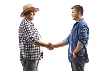 Mature farmer shaking hands with a young casual man