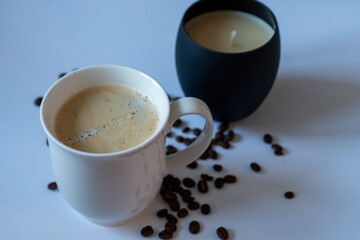 cup of coffee and beans, candle