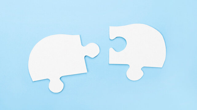 Two puzzle pieces. Conceptual image of connection, teamwork and business strategy.