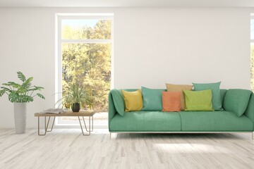 Fototapeta na wymiar Stylish room in white color with sofa and autumn landscape in window. Scandinavian interior design. 3D illustration