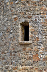Fototapeta na wymiar old brick tower wall with window