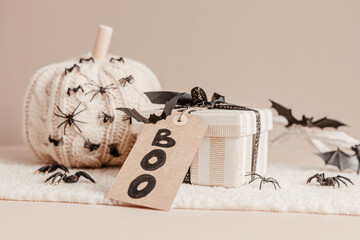 Modern interior decoration for halloween celebration with handmade knit pumpkin, spiders, bats and gift box - obrazy, fototapety, plakaty