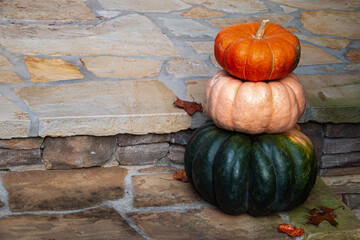 Triple decker heirloom pumpkins decorating the front porch for autumn.