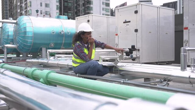 Factory engineer or maintenance technician inspects the chiller, Air conditioner, Air chillers, HVAC of large industrial plants.