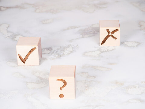 Wooden cubes with check marks as choice and decision making concept