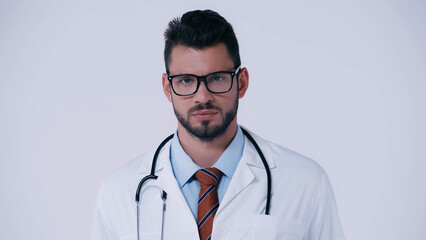 bearded doctor in eyeglasses and with stethoscope looking at camera isolated on grey.