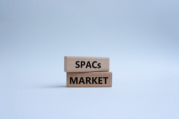 SPACs market symbol. Concept words SPACs market - special purpose acquisition companies market - on wooden blocks. Beautiful white background. Business concept. Copy space.